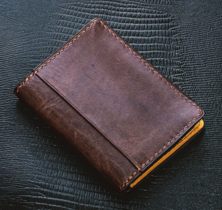 Leather wallet on a dark textured backdrop, before background removal