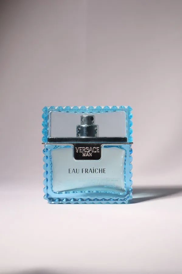 Perfume bottle on a plain backdrop, before background removal