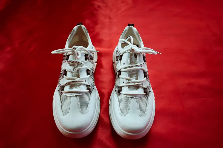 Sneakers on a red backdrop, before background removal